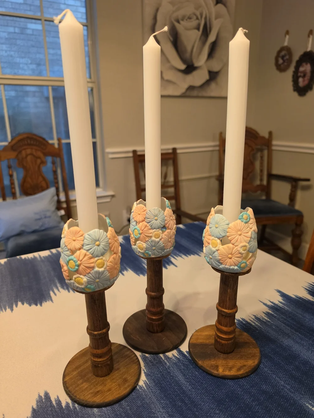 Trio Of Turned dark wood candlestick holders pastel-colored sculpted floral cups